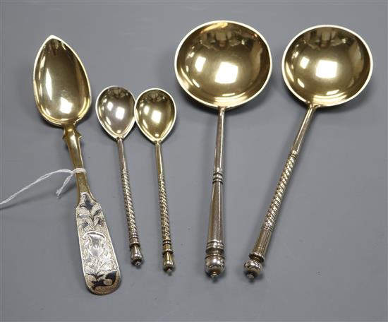 A Russian 84 zlotnik silver gilt and niello spoon, assay master probably Andrei Koralsky, 1842, L 17.5cm and four other Russian spoons